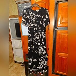 A Calvin Klein Floral Black and White lined maxi Dress in a size 12. Pre-loved
